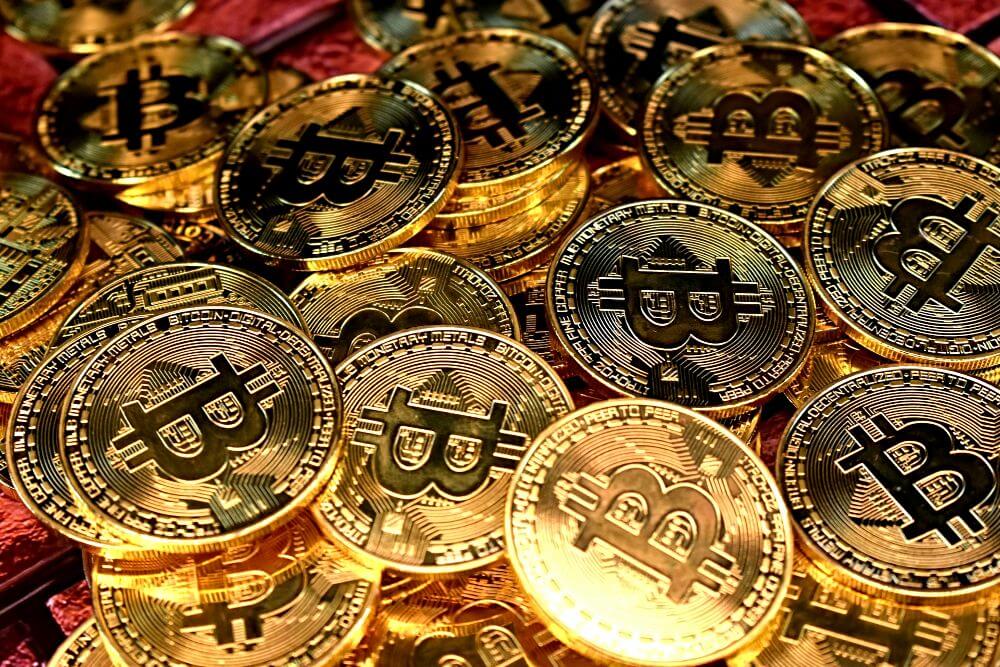 Bitcoin crypto represented by piles of golden BTC coins