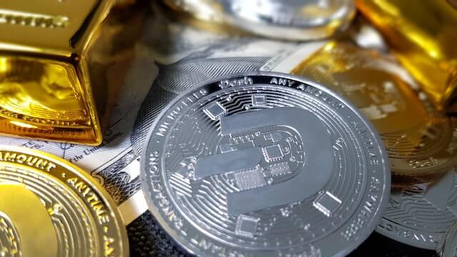 Dash cryptocurrency represented by physical silver and gold coins. 