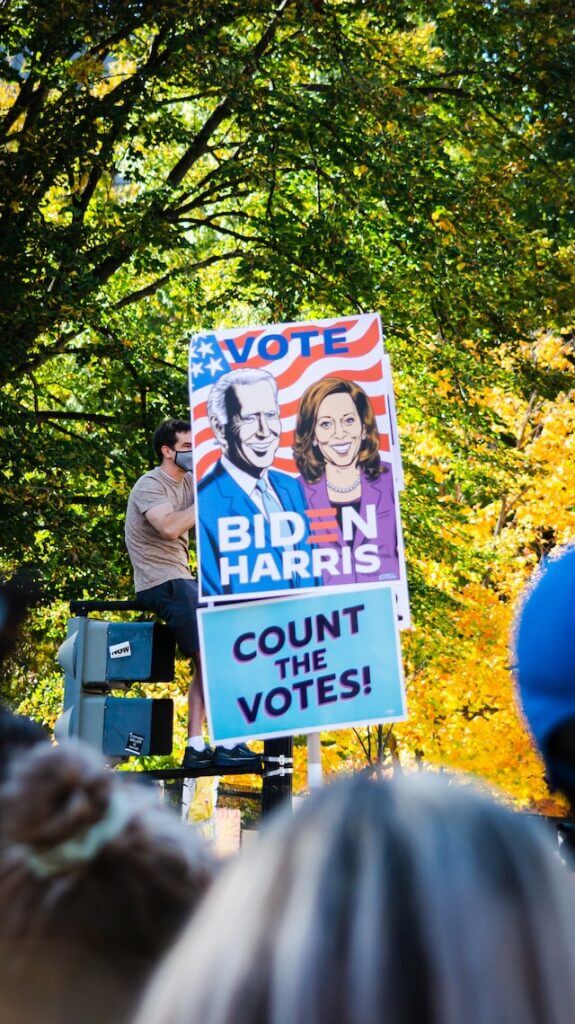 Democrat supporters holding a Biden Harris placard