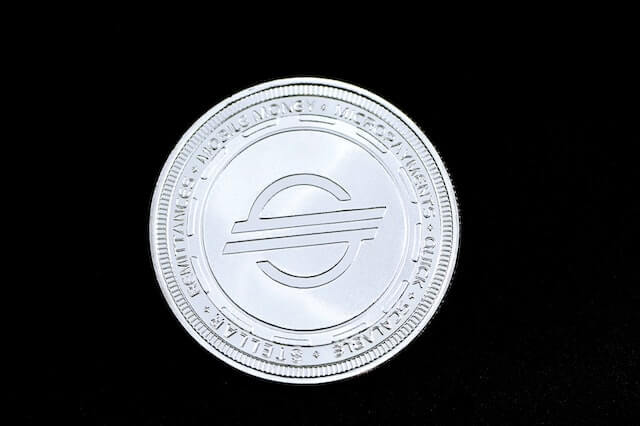 Stellar Lumens (XLM) cryptocurrency, represented by a physical silver coin.