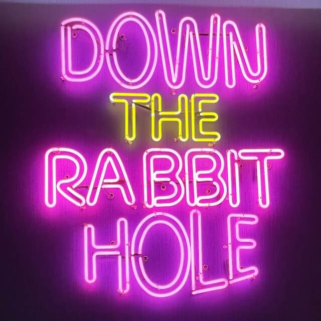 Down the Rabbit Hole text in neon