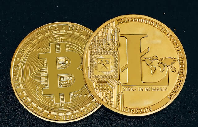 Bitcoin (BTC) and Litecoin (LTC) cryptocurrency, represented by physical coins.