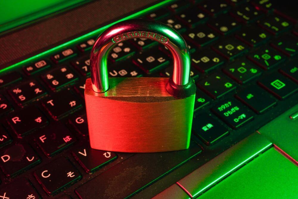 Locked padlock on top of laptop keyboard.